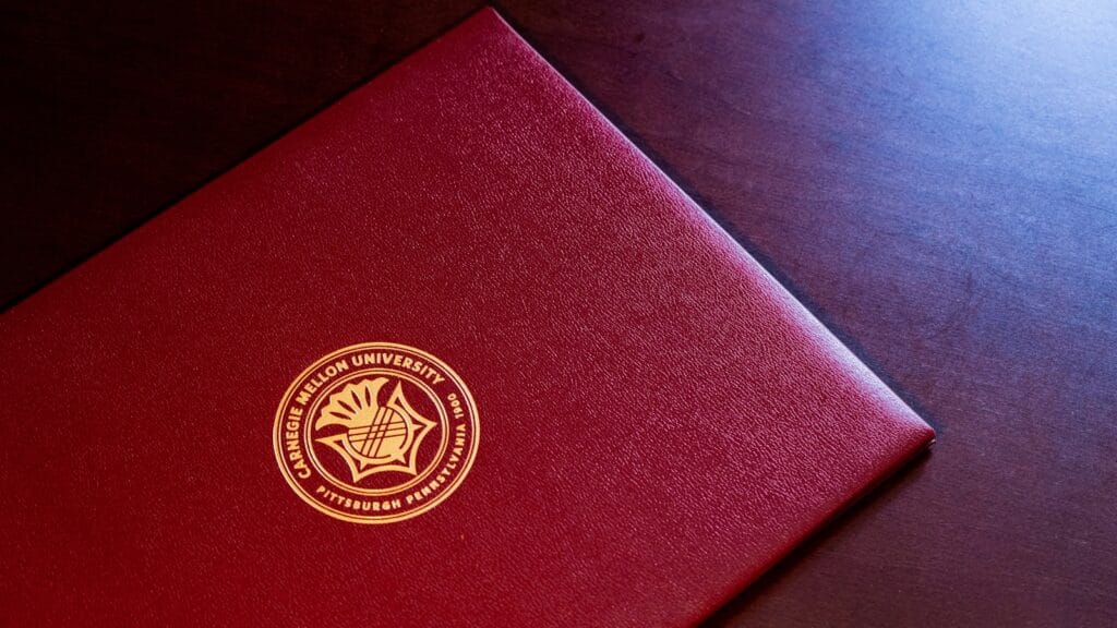 red and gold book on black textile